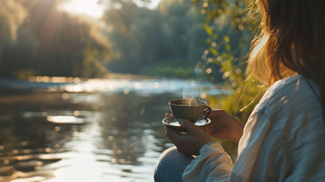 Woman practicing self-care outdoors, enjoying a peaceful moment with tea in nature, promoting relaxation, mindfulness, and mental well-being