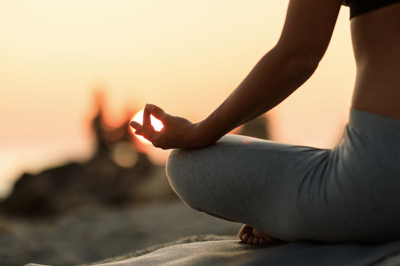 Peaceful woman sitting cross-legged in a serene room, demonstrating what to do during meditation for beginners seeking calm and mindfulness.